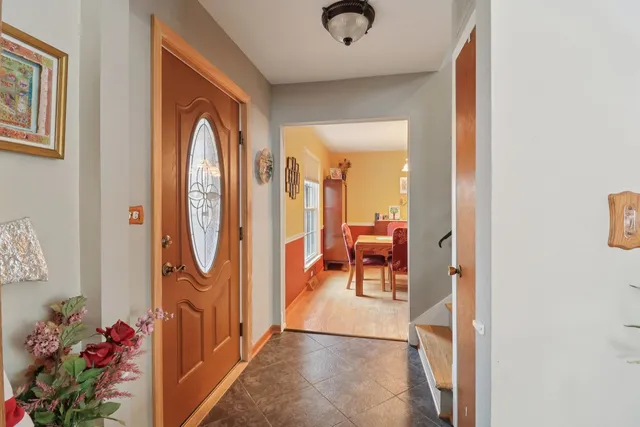 a view of a hallway with dining room and front door