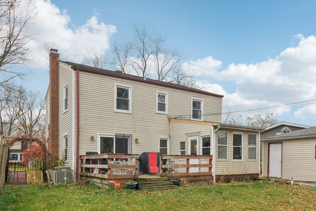 a backyard of a house with outdoor seating
