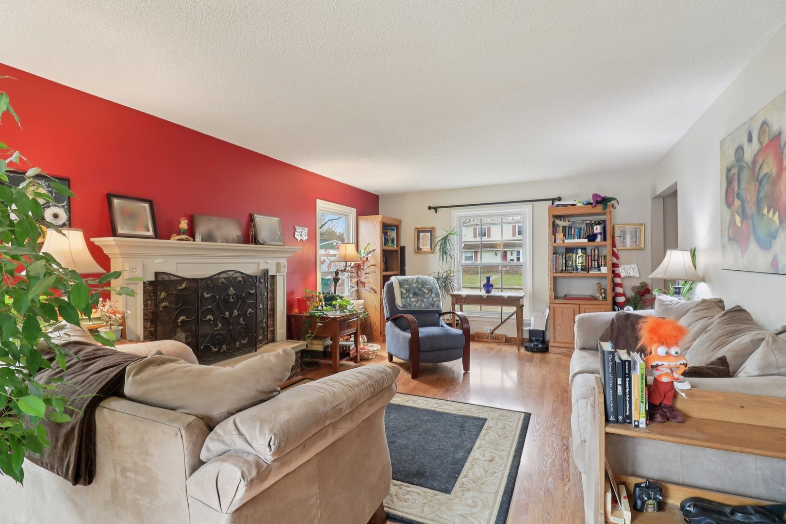 610 Maple Drive Buffalo Grove, IL 60089 - Photo 5 of 39 a living room with furniture large window and a fireplace
