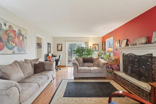 a living room with furniture a fireplace and a window