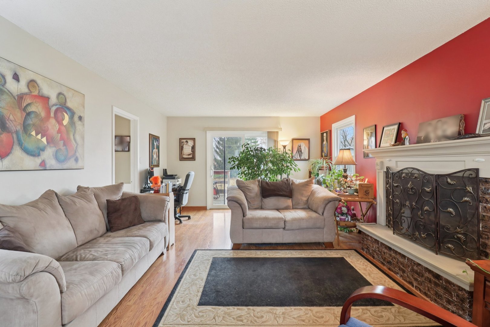 610 Maple Drive Buffalo Grove, IL 60089 - Photo 7 of 39 a living room with furniture a rug and a fireplace