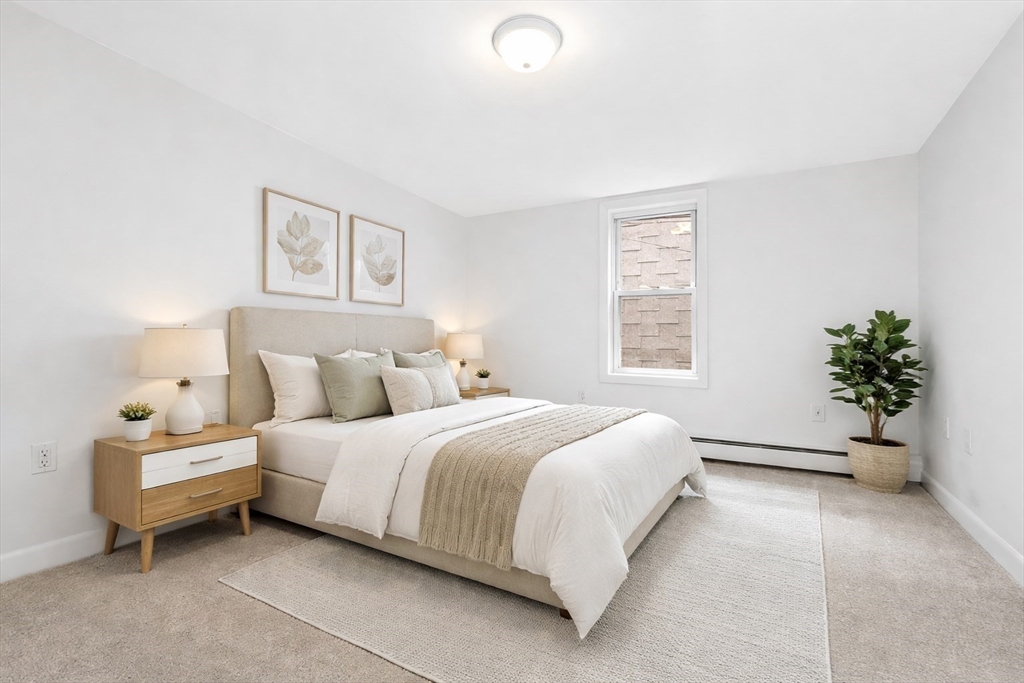 18 R Polk Street Boston, MA 02129 - Photo 15 of 19 a spacious bedroom with a bed and a window