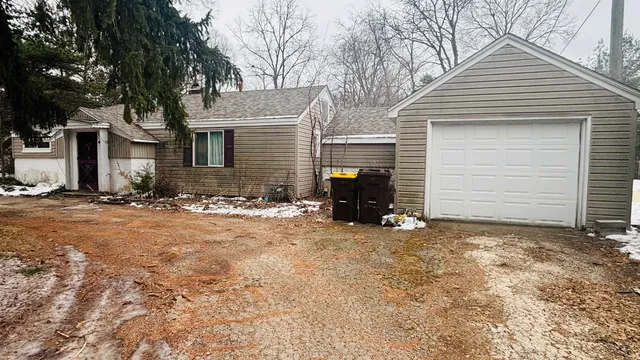 a view of a house with a yard and garage