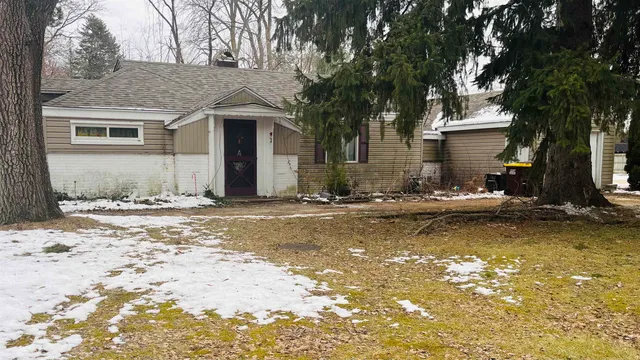 a view of a house with a yard covered with snow
