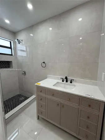 a bathroom with a double vanity sink toilet and shower