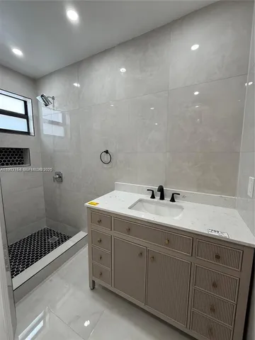 a bathroom with a double vanity sink toilet and shower