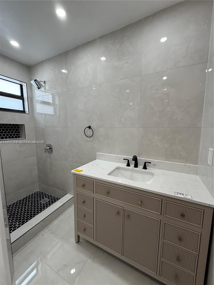 a bathroom with a double vanity sink toilet and shower