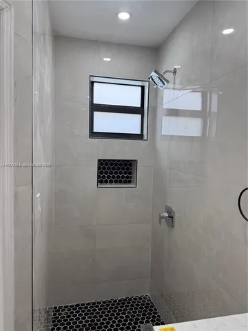 a bathroom with a shower and a sink