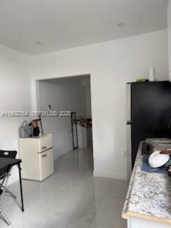 Miramar Tropical Miramar, FL 33023 - Photo 4 of 6 a living room with furniture and a rug