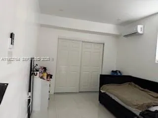 a bedroom with a bed and cabinets