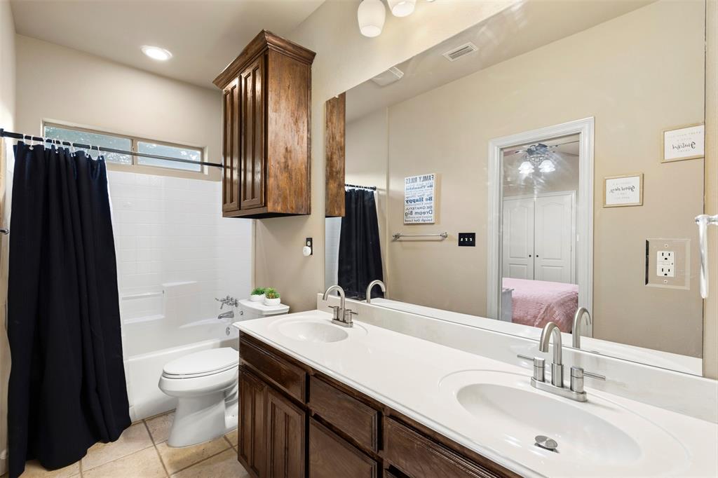 105 Country Ridge Court Red Oak, TX 75154 - Photo 28 of 40 a bathroom with a double vanity sink toilet and shower