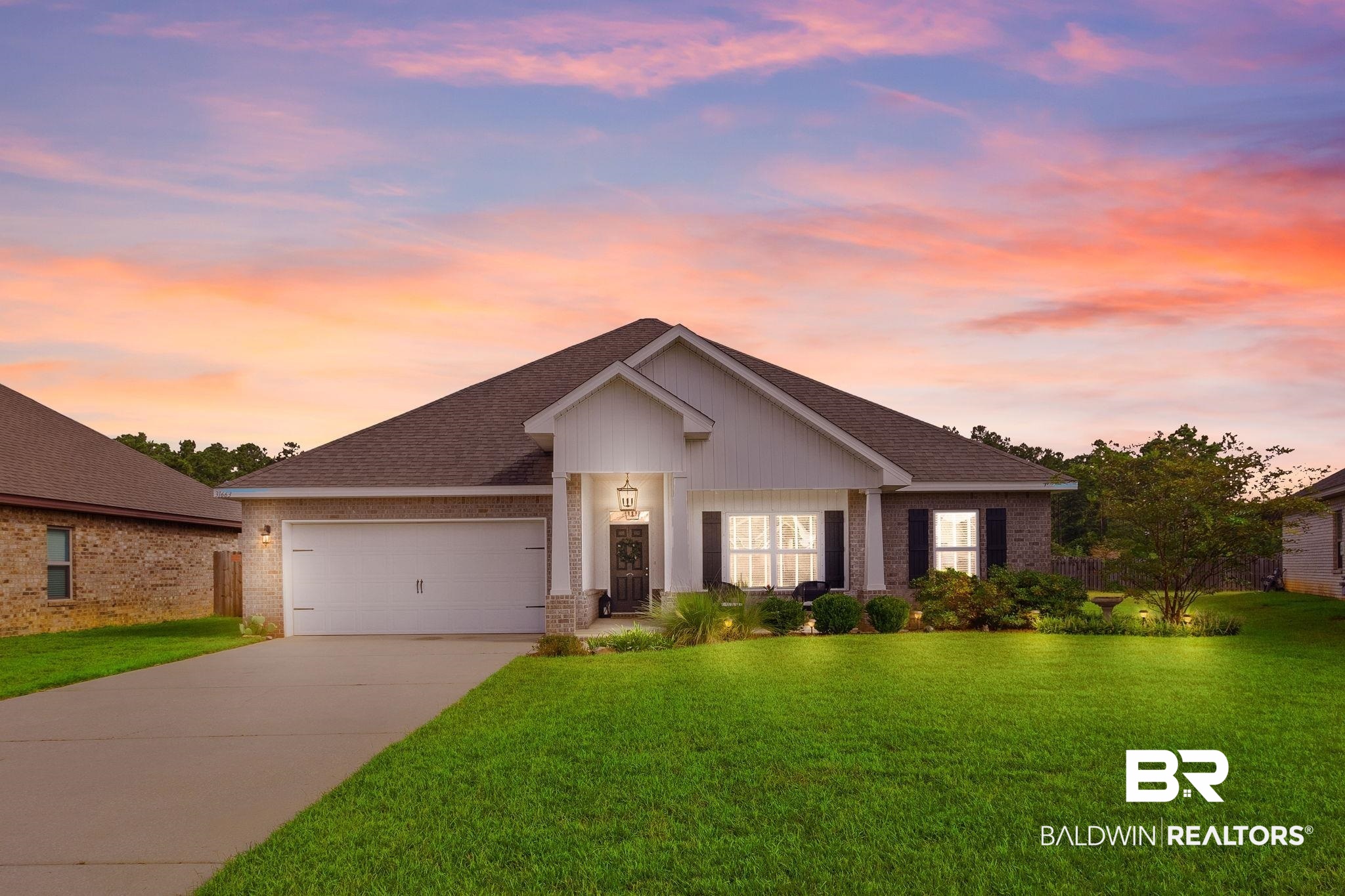 31663 Kestrel Loop Daphne, AL 36527 - Photo 1 of 86 View of front of property featuring a garage and a lawn