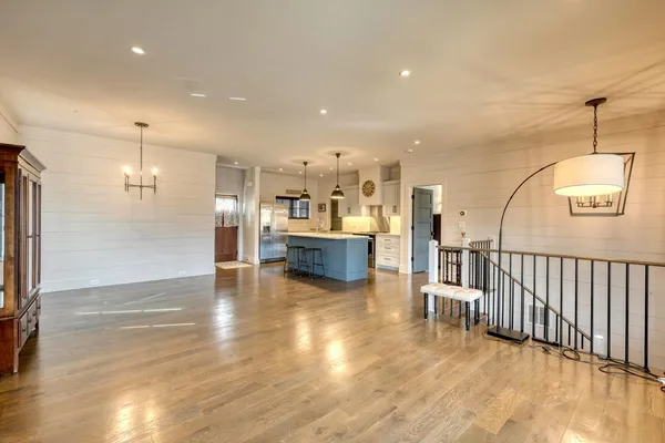 a view of a livingroom with wooden floor and a fireplace