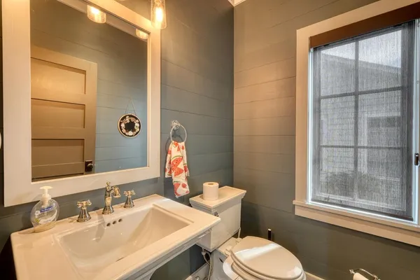 a bathroom with double vanity sinks and a shower