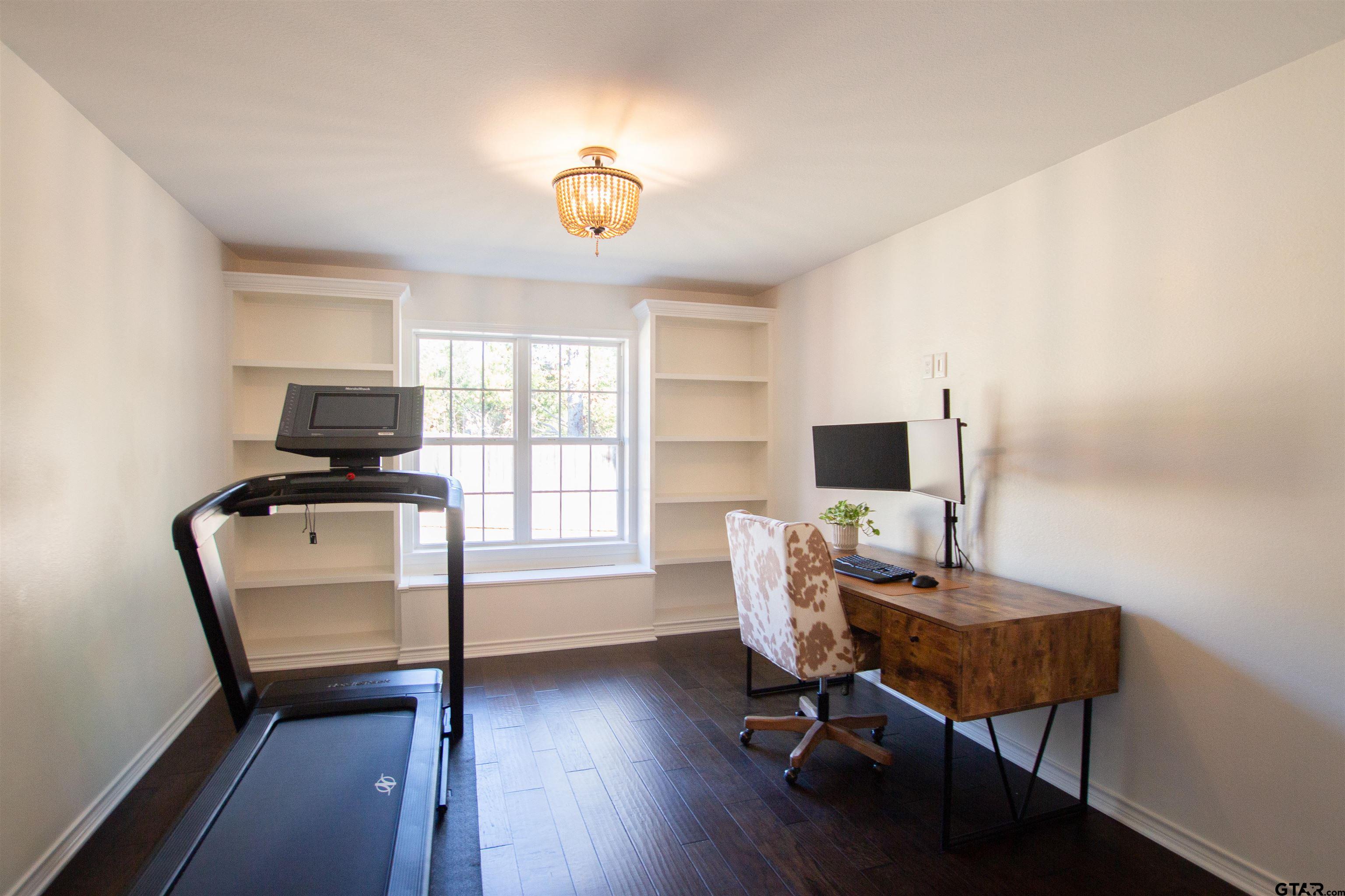 2618 Prestwick Road Jacksonville, TX 75766 - Photo 12 of 38 a workspace with furniture hardwood and a window