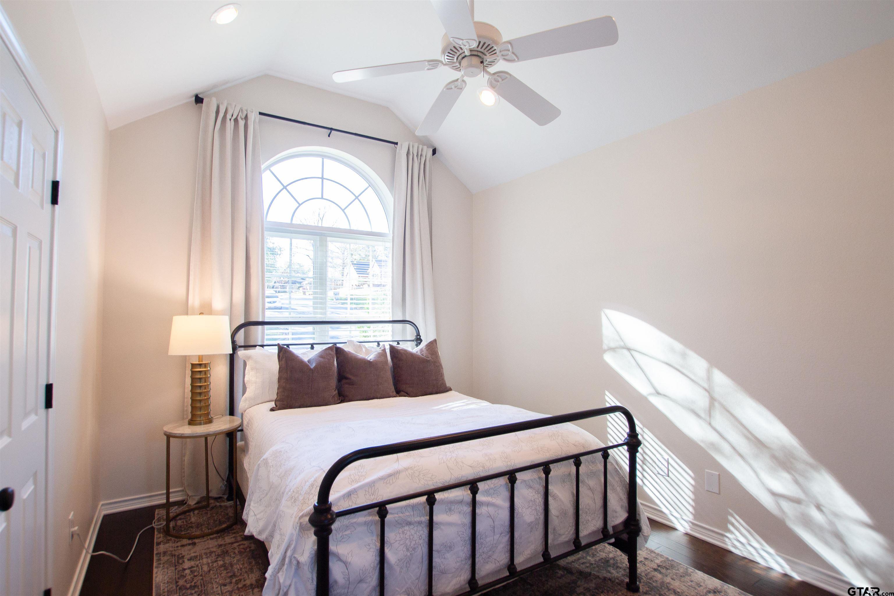 2618 Prestwick Road Jacksonville, TX 75766 - Photo 18 of 38 a bedroom with a large bed and a window