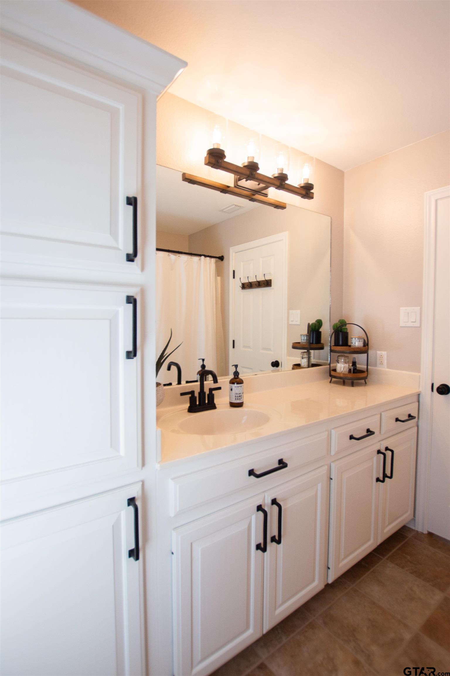 2618 Prestwick Road Jacksonville, TX 75766 - Photo 23 of 38 a bathroom with a sink vanity and mirror