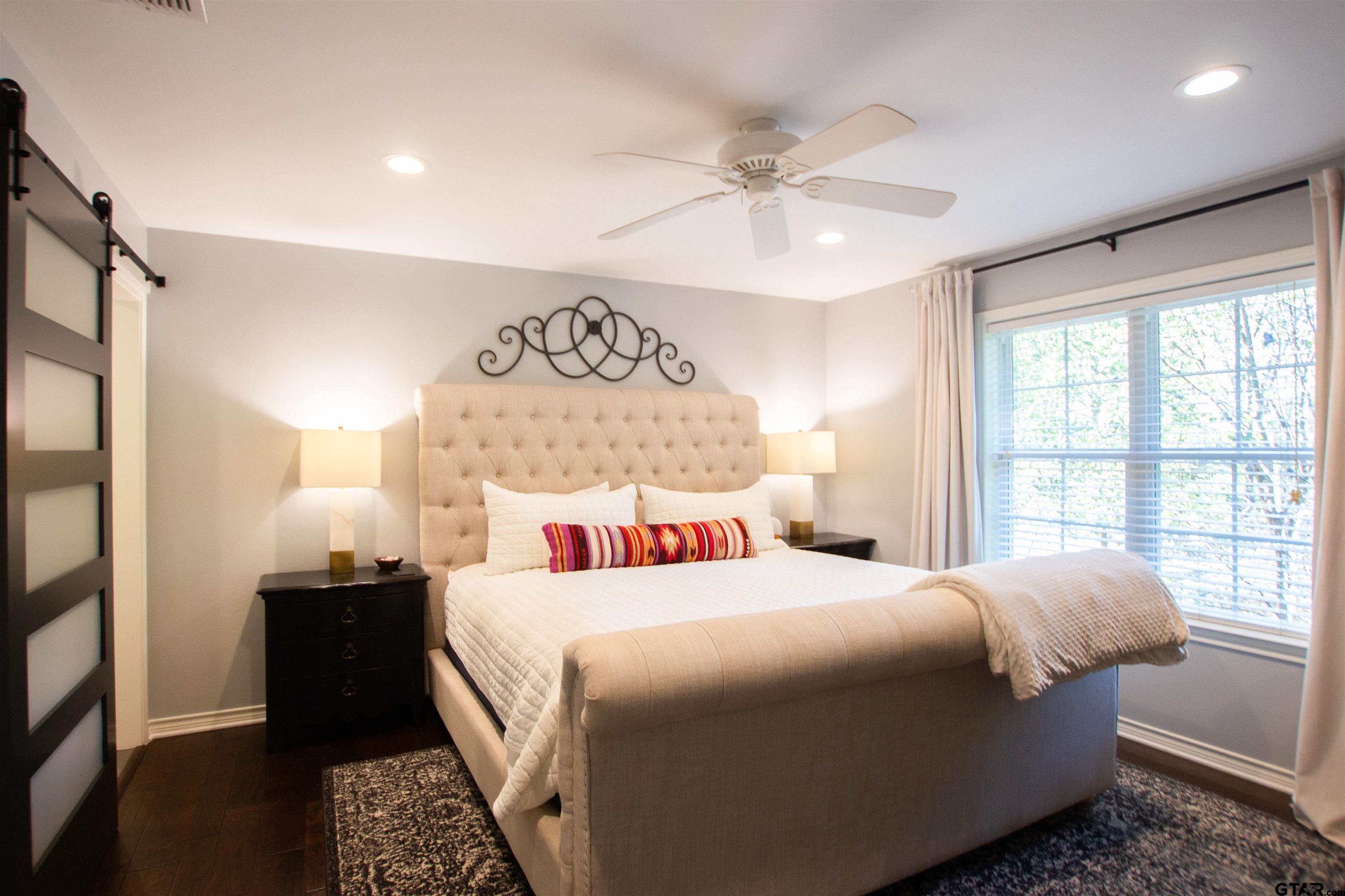 2618 Prestwick Road Jacksonville, TX 75766 - Photo 25 of 38 a bedroom with a bed and wooden floor