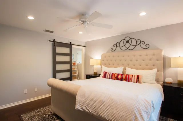 a bedroom with a bed and a night stand