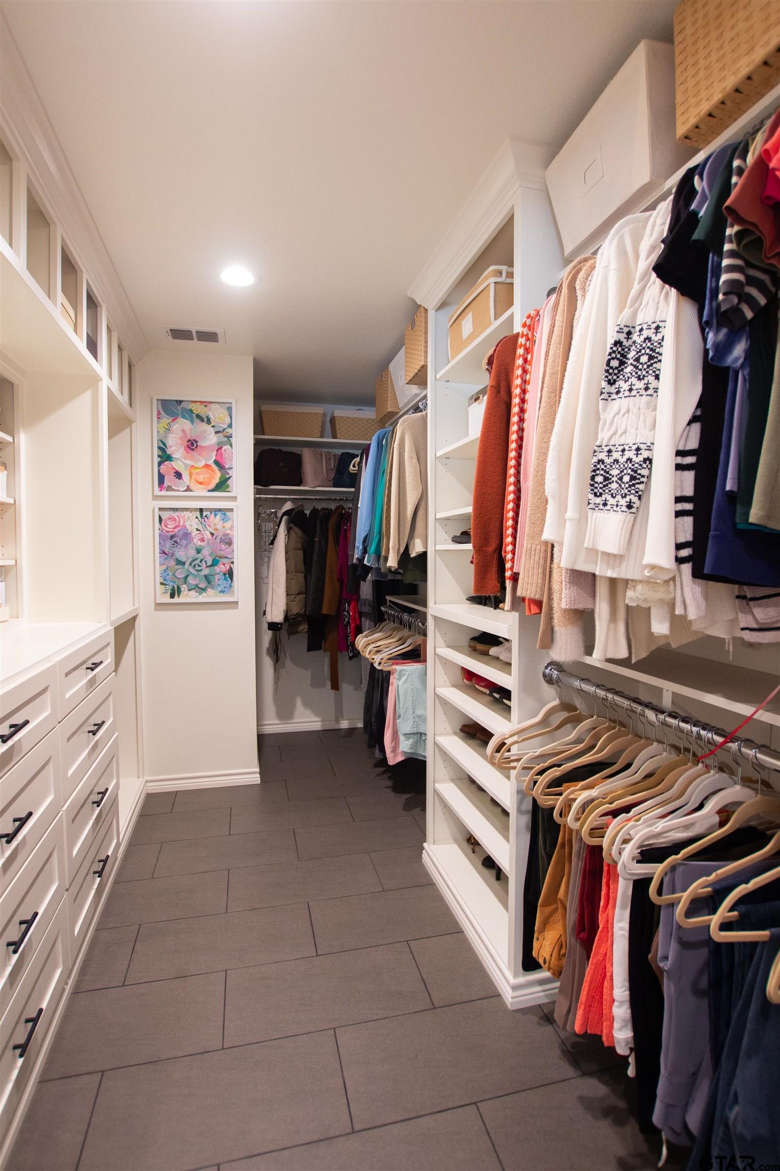 2618 Prestwick Road Jacksonville, TX 75766 - Photo 28 of 38 a view of walk in closet with clothes and shoes