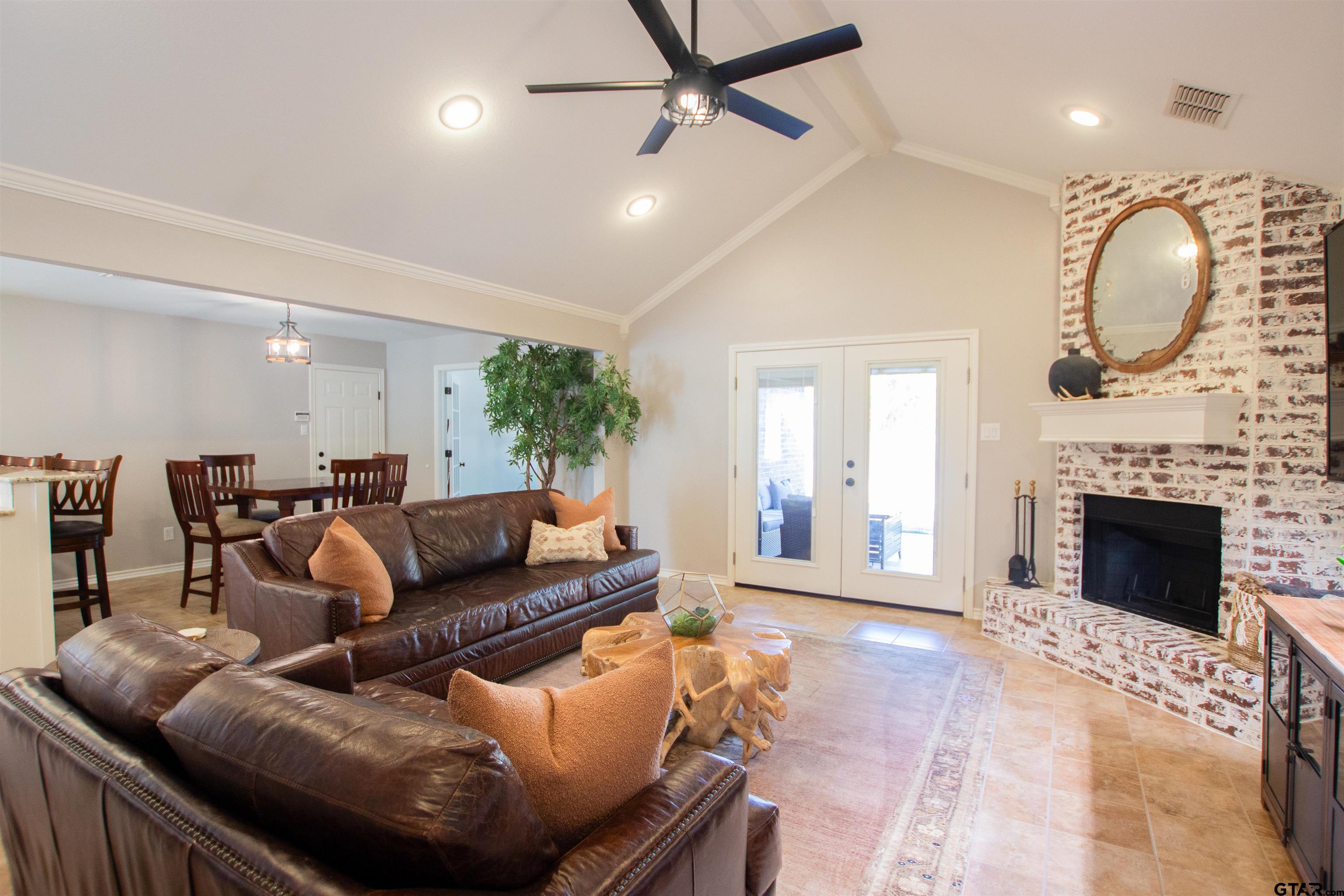 2618 Prestwick Road Jacksonville, TX 75766 - Photo 5 of 38 a living room with furniture a large window and a fireplace
