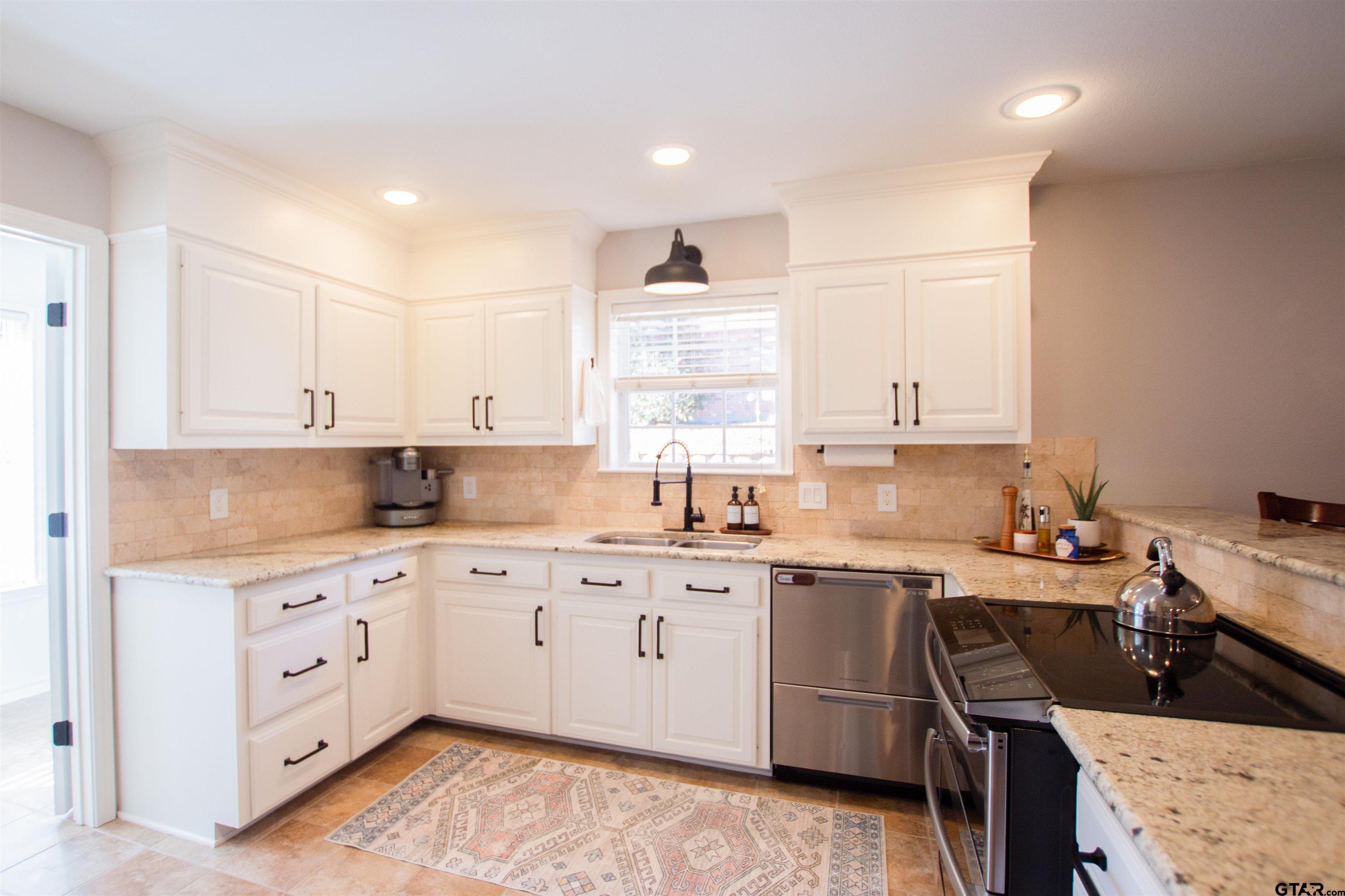 2618 Prestwick Road Jacksonville, TX 75766 - Photo 7 of 38 a kitchen with a sink window and cabinets