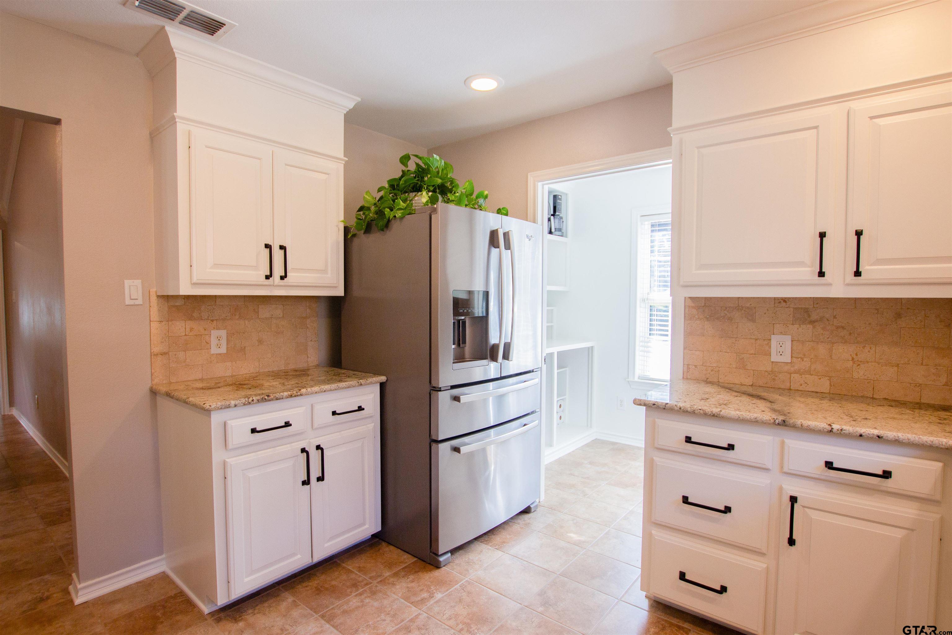 2618 Prestwick Road Jacksonville, TX 75766 - Photo 9 of 38 a kitchen with cabinets and stainless steel appliances