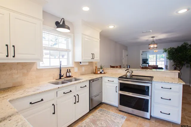a kitchen with white cabinets and white appliances