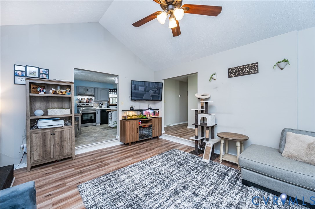 12190 Pinyon Lane Ruther Glen, VA 22546 - Photo 13 of 36 a living room with furniture and a flat screen tv