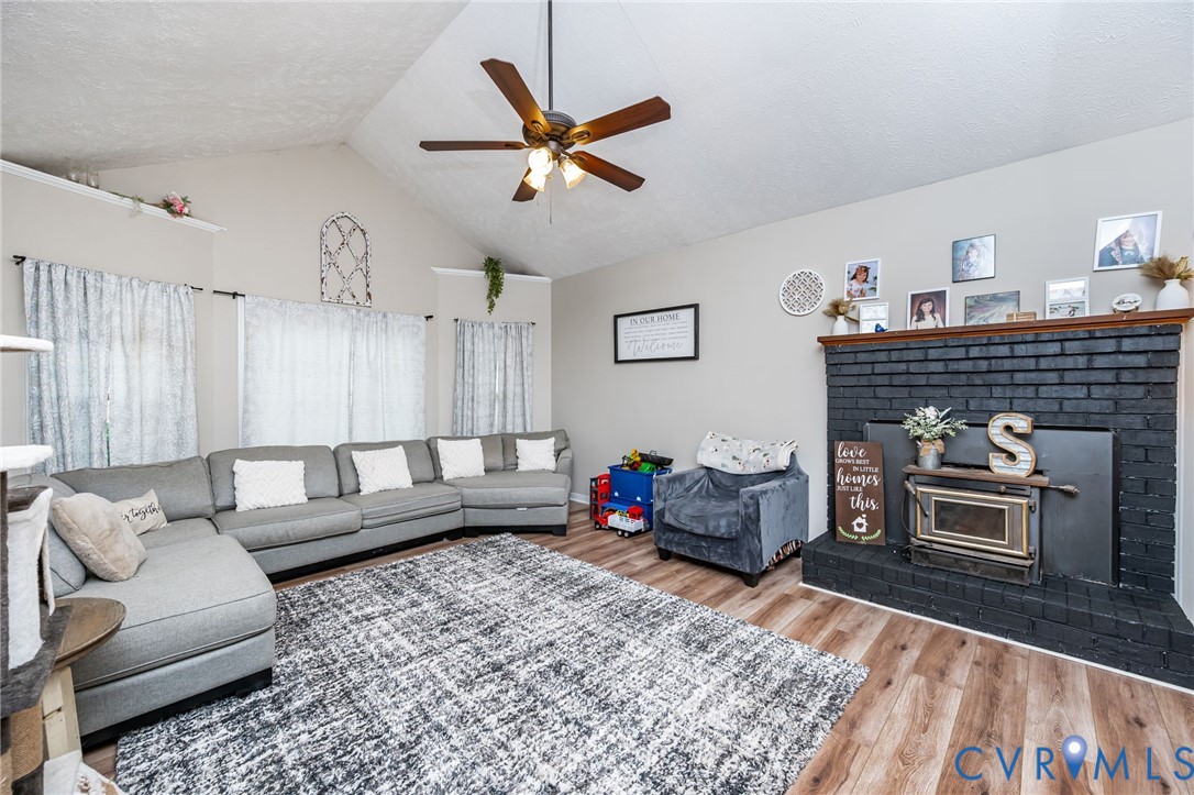 12190 Pinyon Lane Ruther Glen, VA 22546 - Photo 14 of 36 a living room with furniture and a fireplace