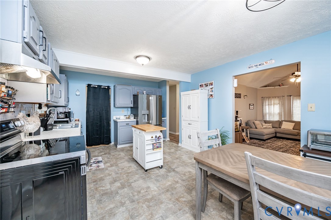 12190 Pinyon Lane Ruther Glen, VA 22546 - Photo 18 of 36 a living room with furniture a window and kitchen view