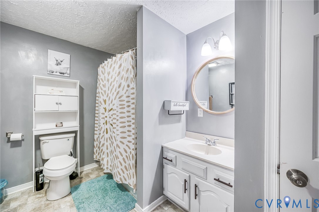 12190 Pinyon Lane Ruther Glen, VA 22546 - Photo 24 of 36 a bathroom with a sink a toilet and shower