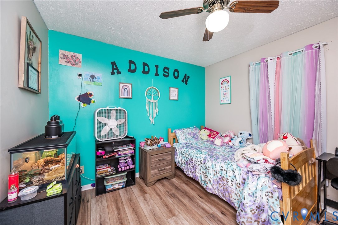 12190 Pinyon Lane Ruther Glen, VA 22546 - Photo 25 of 36 a bedroom with a bed and wooden floor