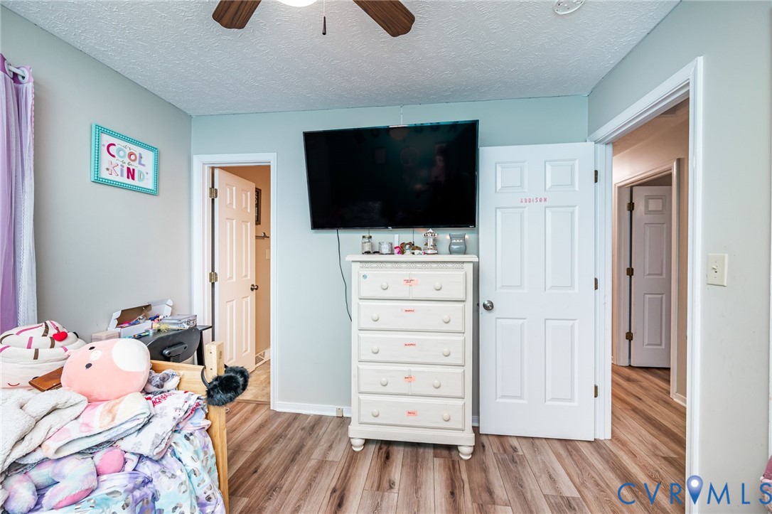 12190 Pinyon Lane Ruther Glen, VA 22546 - Photo 26 of 36 a bedroom with a bed and flat screen tv