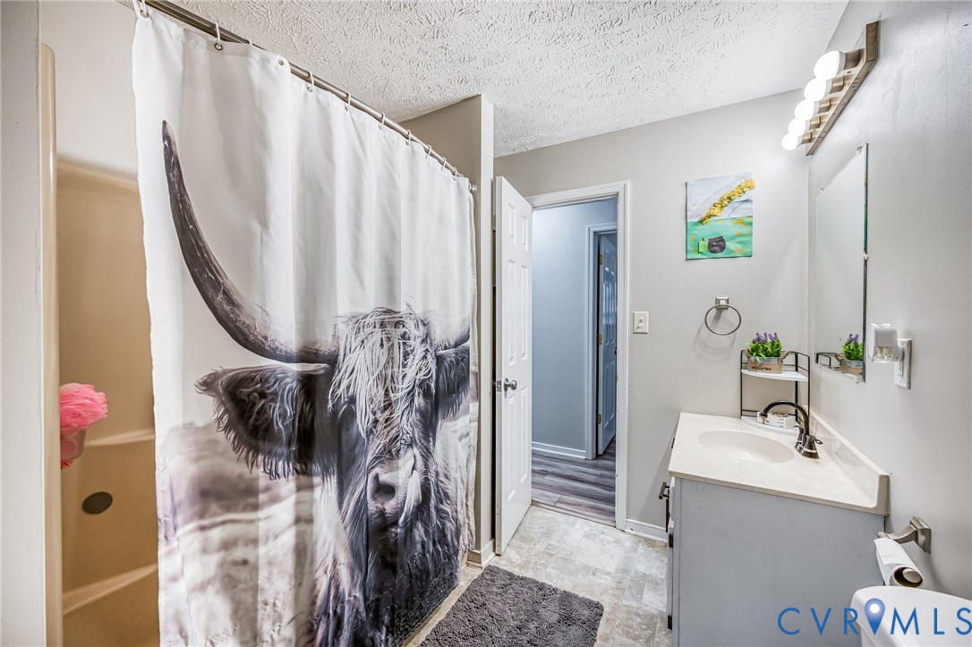 12190 Pinyon Lane Ruther Glen, VA 22546 - Photo 27 of 36 a bathroom with a sink and mirror