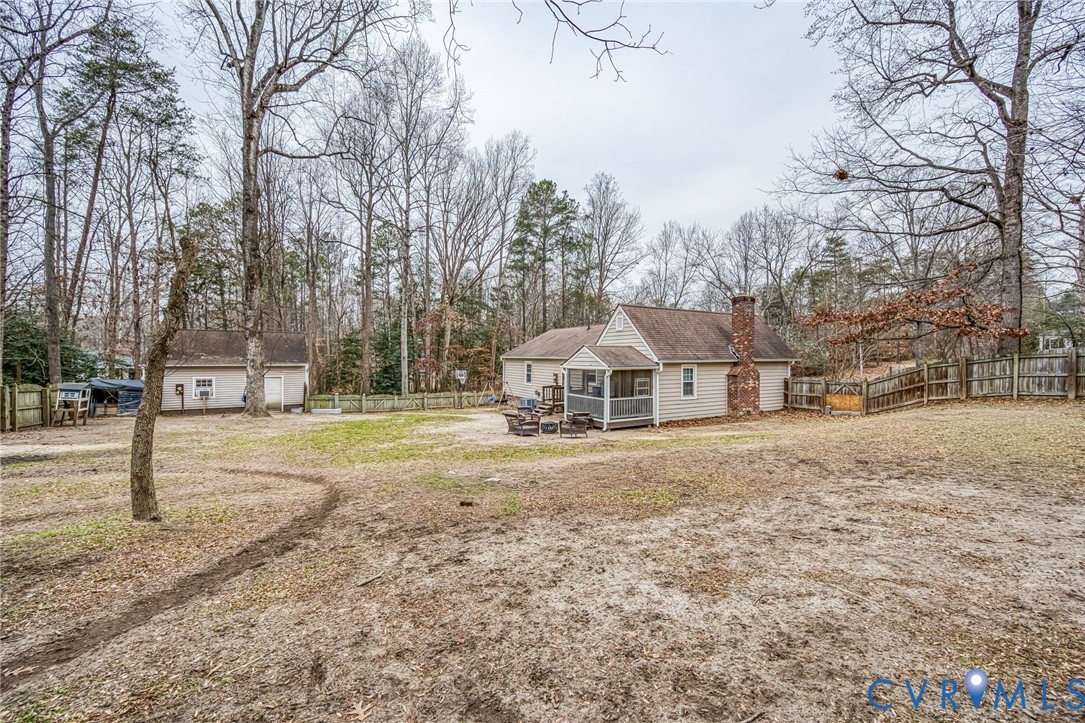 12190 Pinyon Lane Ruther Glen, VA 22546 - Photo 33 of 36 a front view of a house with a yard covered with trees