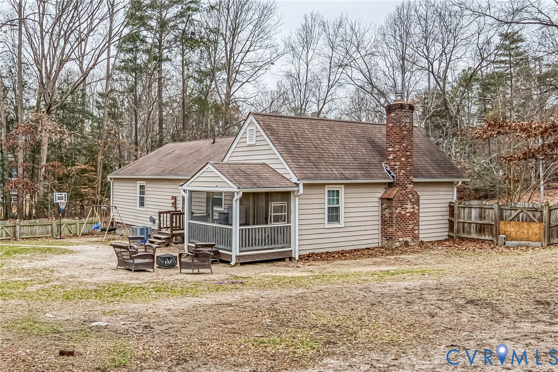 12190 Pinyon Lane Ruther Glen, VA 22546 - Photo 34 of 36 a view of a house with a yard chairs and floor to ceiling window