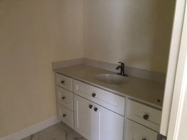 a bathroom with a sink and vanity