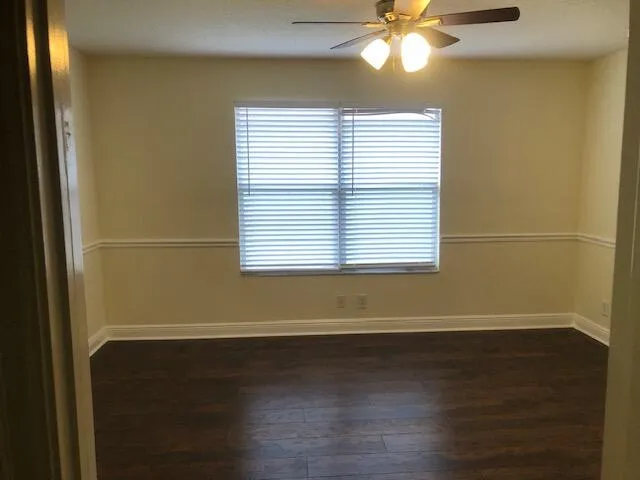 a view of a room with wooden floor and a window