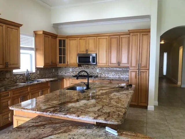 a kitchen with a refrigerator a stove a sink and a window