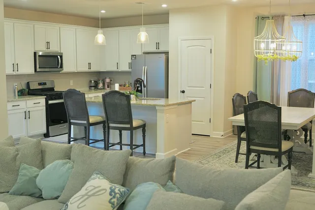 a living room with furniture a refrigerator and a fireplace