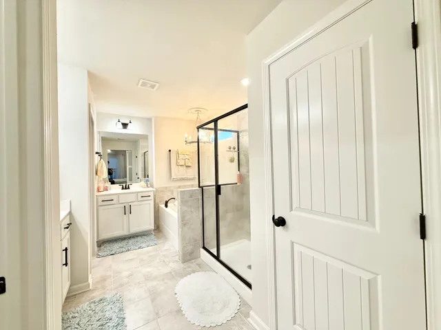 a bathroom with a granite countertop sink mirror and shower