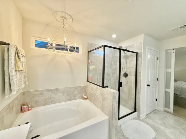 a bathroom with a bathtub and a shower