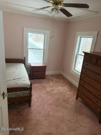 a view of a livingroom with furniture and staircase