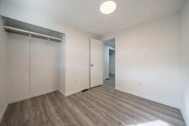 a view of room with wooden floor