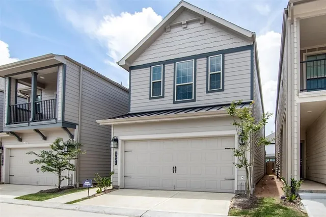 a view of a house with a garage and window