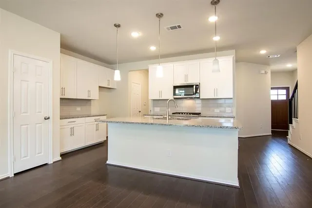 a large kitchen with cabinets