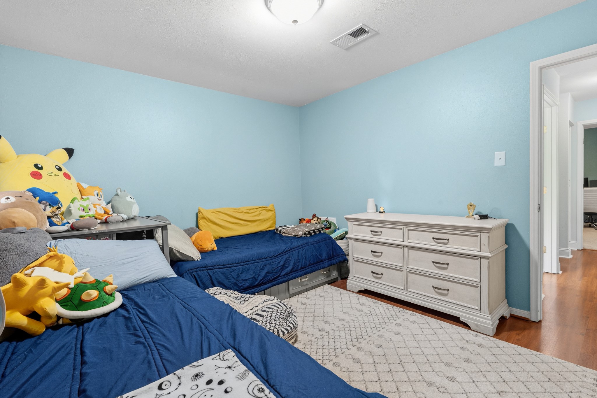2104 Rose Road Pearland, TX 77581 - Photo 31 of 43 a bedroom with a bed and a dresser