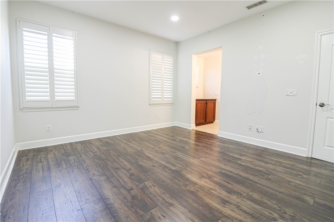 2850 North Stone Pine Glen Santa Ana, CA 92706 - Photo 16 of 45 an empty room with wooden floor and windows