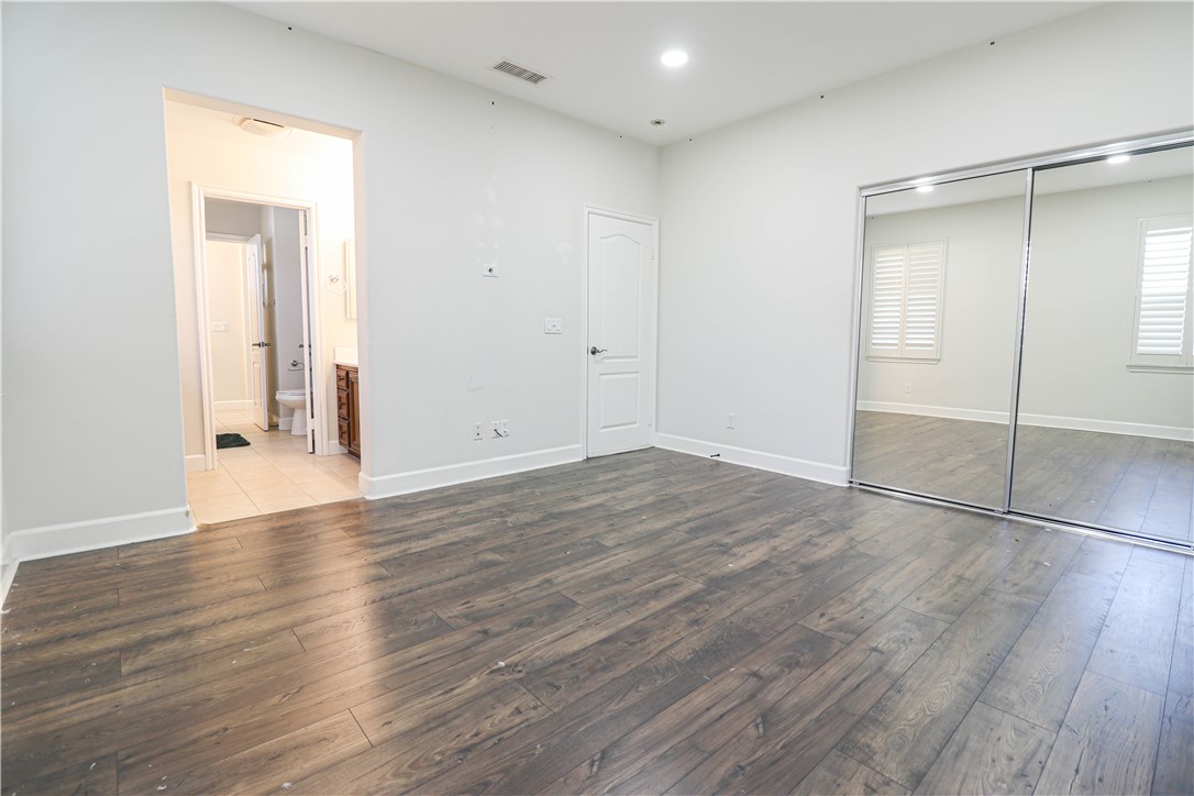2850 North Stone Pine Glen Santa Ana, CA 92706 - Photo 17 of 45 an empty room with wooden floor and closet area